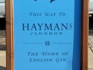 sandwich board pointing to the Home of English Gin