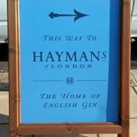 sandwich board pointing to the Home of English Gin